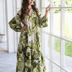 Beautiful young woman is looking out the window