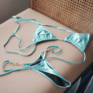 Close up of woman bra throwing at wooden chair.